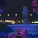 Layla and Marc hold hands in a party boat in a scene from Moon Knight.
